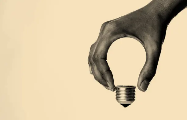 creative image of a hand silhouetting the outline of a lightbulb
